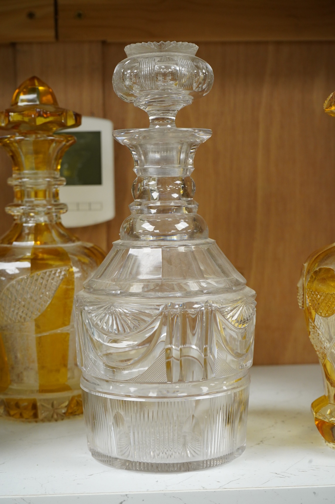Two late 19th century Bohemian amber flashed decanters and another decanter, tallest 26cm